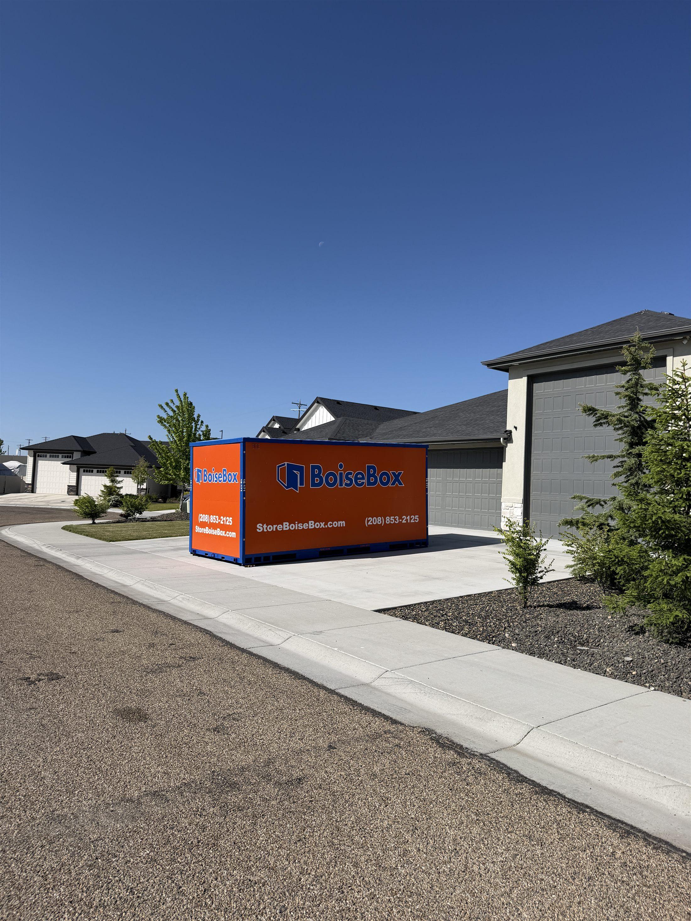 BoiseBox delivery truck placing a portable storage container